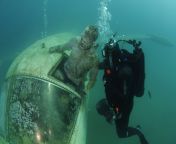 extracting corpse from underwater airplane wreck, training exercise ---- As far as I&#39;ve gathered, the corpse is fake for the sake of training. Still incredibly creepy though. from corpse