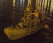 Marine Raiders with 1st Marine Raider Battalion (1st MRB) pictured aboard a Naval Special Warfare Rigid Hull Inflatable Boat (NSW RHIB) during a night raid. from 1st night rap tamil a