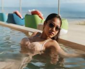 Busty Asian babe in sunglasses relaxing in swimming pool under the sun from mallu devika in swimming pool