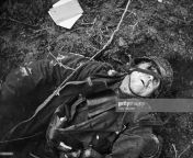 A German machine-gunner lies dead in a field after being struck in the eye by a bullet, World War II from kally gunner