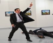 A gunman gestures after shooting the Russian Ambassador to Turkey, Andrei Karlov, at a photo gallery in Ankara, Turkey, Monday, Dec. 19, 2016. [702x960] from www image gallery in