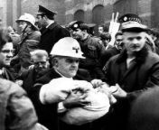 Leading Ambulanceman Bob Scott removes the body of the youngest victim, Colin Nichol, from under the rubble after the Balmoral Furniture Company bombing. (Belfast, Northern Ireland. 11 December 1971) from bd company 237