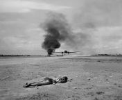May, 1944 - Myitkyina Airfield, Burma - A dead Japanese soldier lies where he was shot, as a C-47 takes off. To the left, another C-47 sits burning, having been strafed by four Japanese Zeroes five minutes previously. (LIFE Magazine) from japanese mother filmress srushti dange