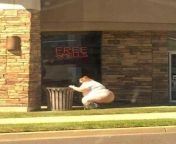 Woman pooping in the streets next to an appropriate sign. from pooping in the mouth