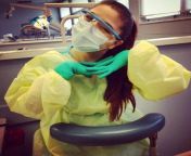 Dental assisting student ready for a procedure in gown, mask and gloves from actress roja in gown