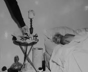 An LAPD officer points to prescription pill bottles on a nightstand next to the lifeless body of Marilyn Monroe lying in bed, August 5th, 1962. from leah remini danny masterson scientology lapd jpg