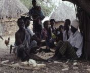 Somali Bantu family shelling corn from somali siil