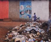 /u/edme took this photo of an annoying sign in Zambia not realizing there was a guy dead or at the very least passed out in a pile of trash (lower right corner) from zambia sweto