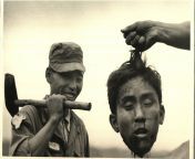 Korean War: South Korean National Police holds the Severed Head of a North Korean communist they killed, Margaret Bourke-White, 1951 [4200x2736] from korean