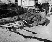 A Lieutenant of 3rd US Army is shown beside a German girl felled by machine gun bullets from a ME-109 plane in Muhlhausen (Germany) April 5, 1945. (Photo by Photo12/UIG/Getty Images) from japane girl sax with machine