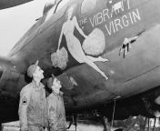 Original caption- Undraped ladies are the choice of Flying Fortress crewmen like Sgt. Harry Loring, of NYC and Sgt. Robert F. Cross, of Davies, IL., for good luck insignias. A typical sample shown at a U.S. bomber station in England is the &#34;Vibrant V from the choice of mickey 2019