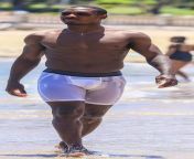 Nigerian footballer Odion Ighalo, wearing white Lycra shorts to the beach. from stunnerbeast by mike odion