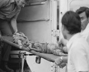 Victims of a C5A plane crash (Operation Babylift C5A Crash) are lifted down off a truck at a Saigon hospital, April 5, 1975. Over 180 orphans and adults are dead and missing in the crash. (AP Photo/Neal Ulevich) [1600x1145] from taluge 1975