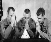 Roger Chaffee, Virgil &#34;Gus&#34; Grissom, and Ed White, the Apollo 1 crew, jokingly praying over a miniature of their command module. All three would die when a flash fire swept through the command module during a test launch on January 27th 1967 from virgil status