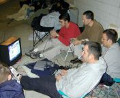 A group of guys outside Best Buy playing PS1 while waiting in line for the greatly anticipated Playstation 2. (2000) from a group of guys sleeping with a girl