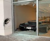 McLaren inside a dealership gets hit by a loose truck wheel from a cat gets rapped by a rabbit