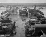 Tanks off-loading from an LCT, June 1944 M4 Sherman tanks, fitted with exhaust stacks for use in water, drive off a Landing Craft Tank towards the beach. from aunty in water tank