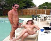 Naked couple relaxing by pool from naked kids by pool