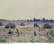 Vietnam War. Battle of Bihn Ba. 6 - 8 June 1969. M113A1 APCs of the 3rd Cavalry Regiment, Royal Australian Armoured Corps (RAAC), advance on the village of Binh Ba after it had been occupied by a strong enemy force (a reinforced company of 1 Battalion, 33 from tamil village royal