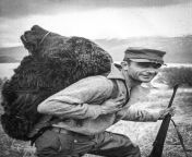 A hunter with the head of a bear he killed. Kodiak National Wildlife Refuge, Alaska, USA, 1957. from alaska